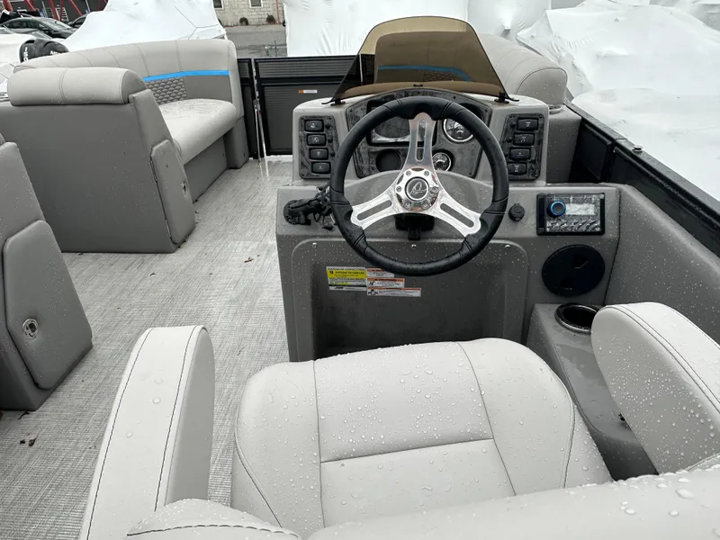 Slide: The Image of 2023 Qwest 818 Lanai LT boat interior with steering wheel and seating. - 15