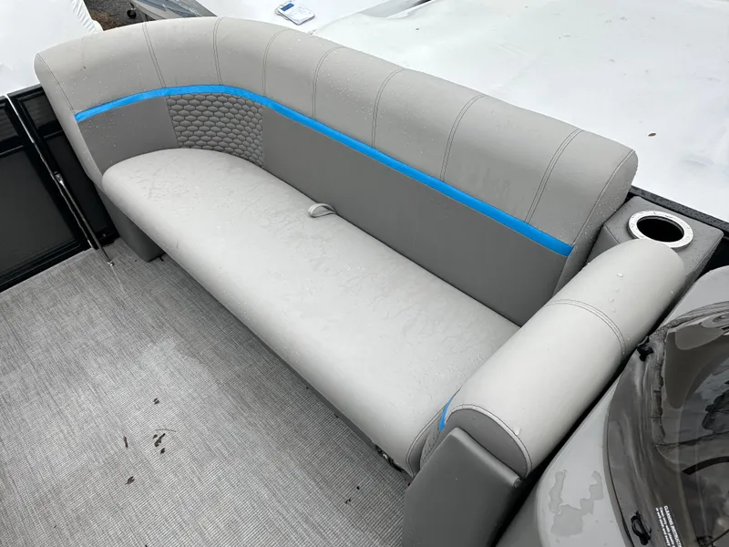 Slide: The Image of 2023 Qwest 818 Lanai LT boat interior with gray seating and blue accents. - 17