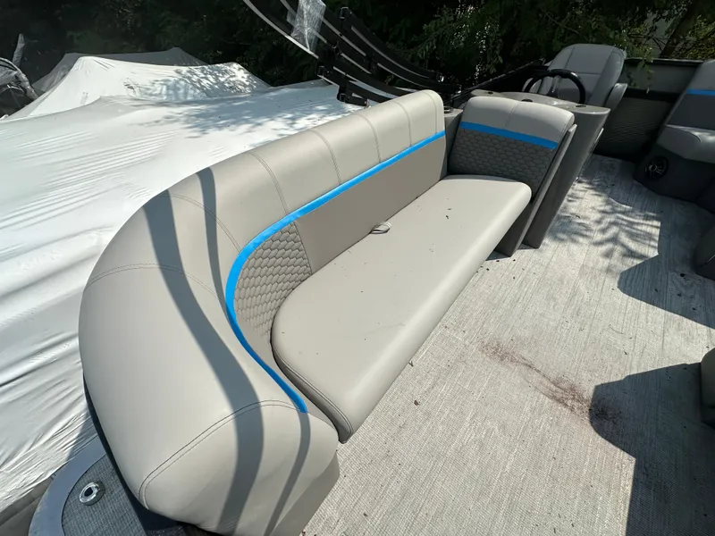 Slide: The Image of 2023 Qwest 818 Lanai LT boat interior with gray seating and blue accents. - 4