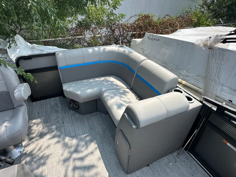 Slide: The Image of 2023 Qwest 818 Lanai LT boat interior with gray seating and blue accents. - 5