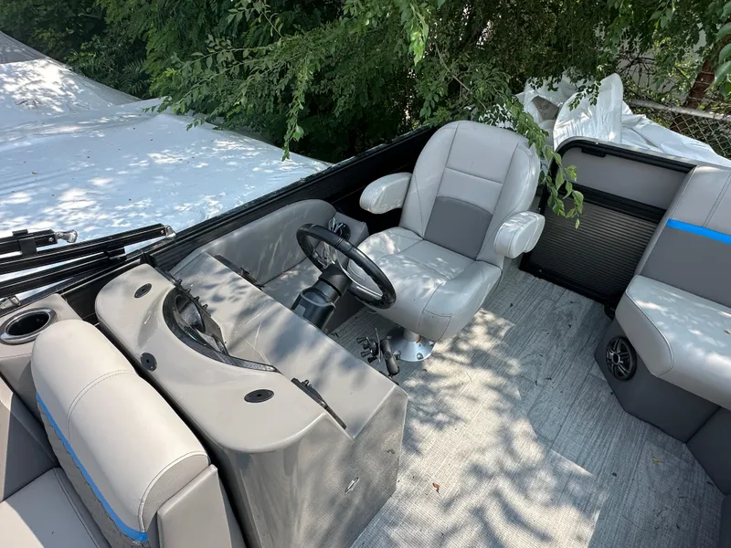 Slide: The Image of 2023 Qwest 818 Lanai LT boat interior with steering wheel and seating. - 6