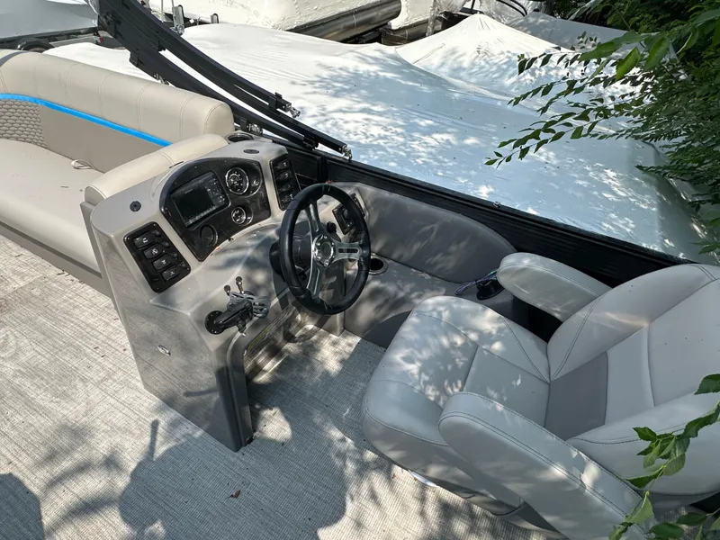 Slide: The Image of 2023 Qwest 818 Lanai LT boat interior with steering wheel and seating. - 7