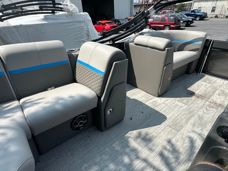 Slide: The Image of 2023 Qwest 818 Lanai LT boat interior with gray seating and blue accents. - 9