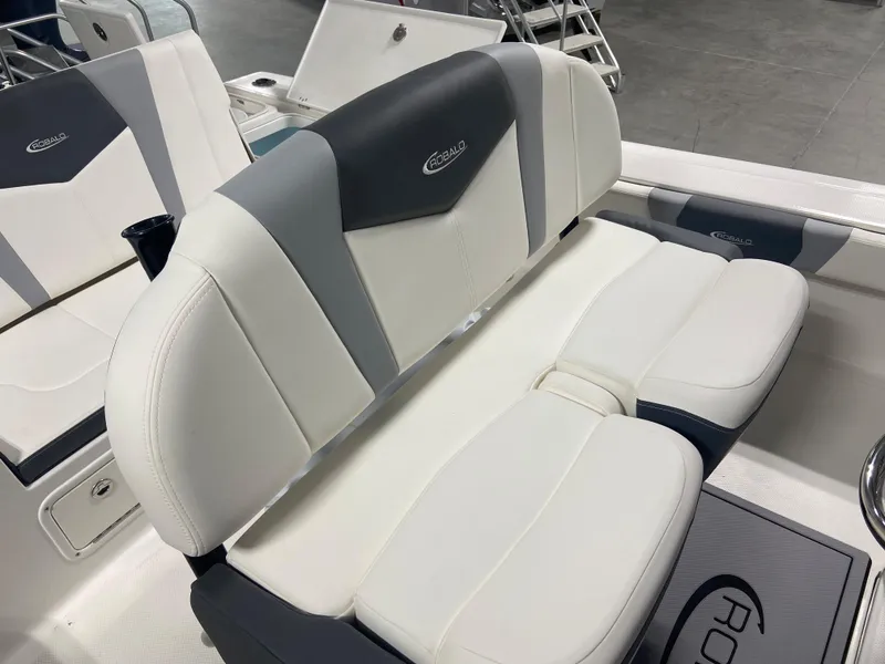 Slide: The Image of 2024 Robalo 246 Cayman boat interior seating with white and gray upholstery. - 11