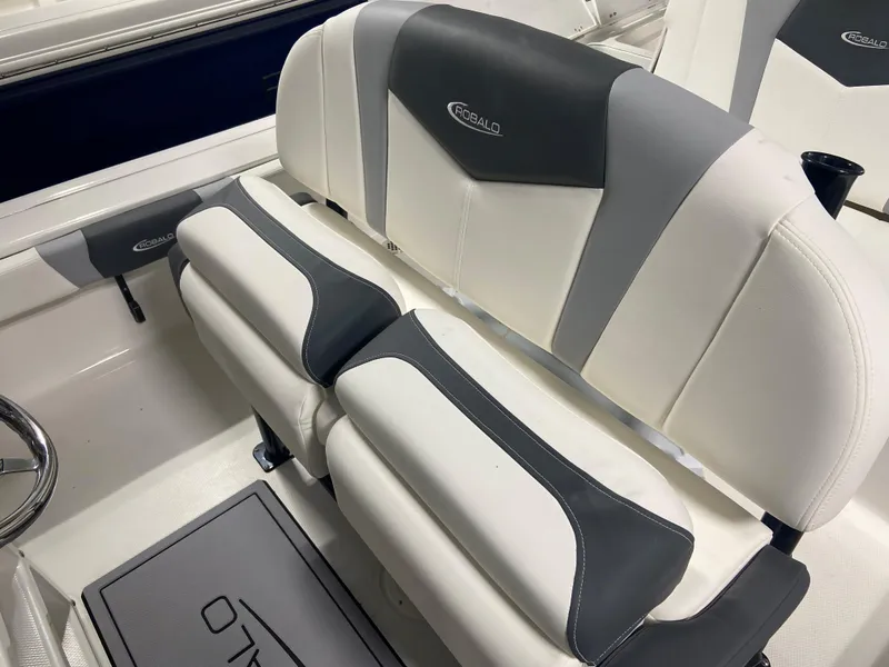 Slide: The Image of 2024 Robalo 246 Cayman boat interior with cushioned seating. - 12