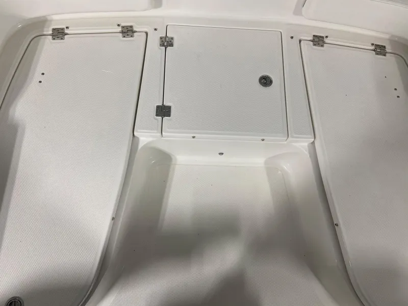 Slide: The Image of 2024 Robalo 246 Cayman boat storage compartments. - 16