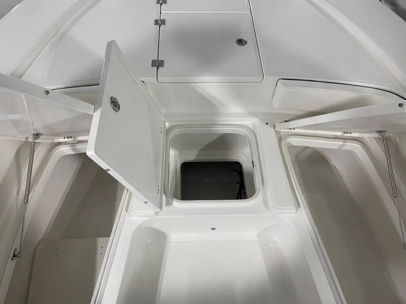 Slide: The Image of 2024 Robalo 246 Cayman boat storage compartments and hatches. - 17