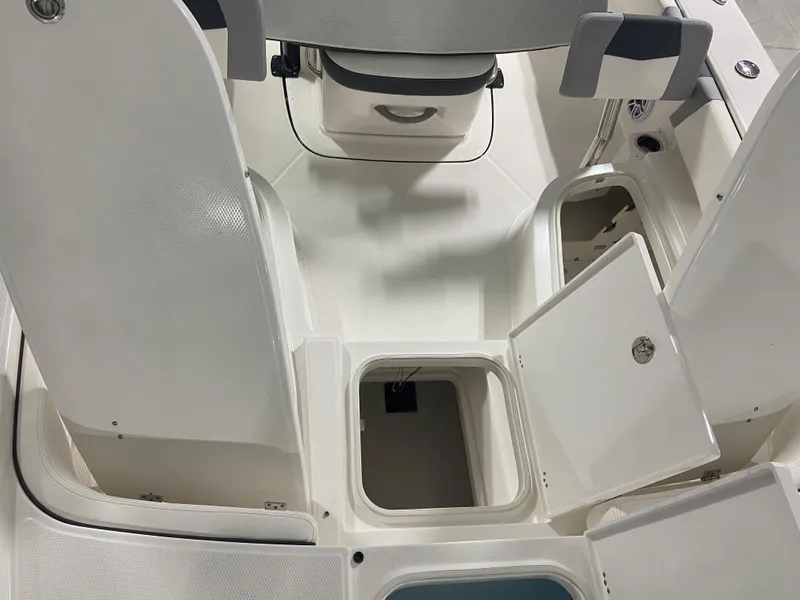 Slide: The Image of 2024 Robalo 246 Cayman boat interior storage compartments and seating. - 18