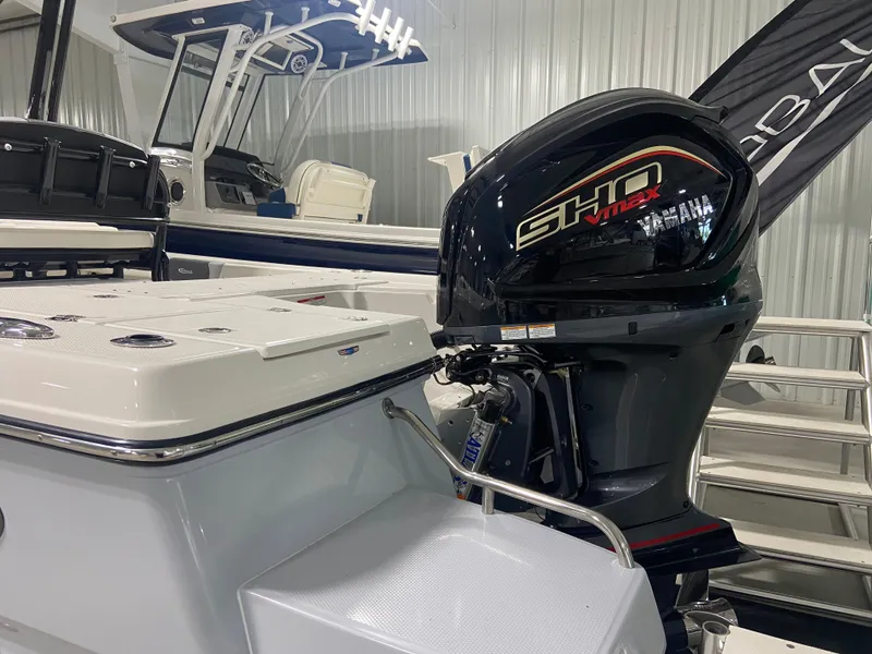 Slide: The Image of 2024 Robalo 246 Cayman boat with Yamaha SHO outboard motor in showroom. - 2
