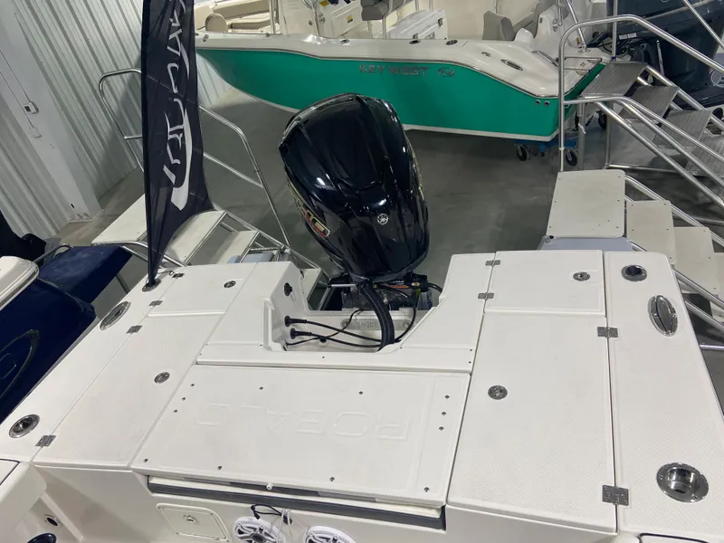Slide: The Image of 2024 Robalo 246 Cayman boat with outboard motor in showroom. - 4