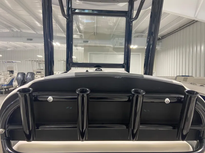 Slide: The Image of 2024 Robalo 246 Cayman boat with rod holders in a showroom. - 5