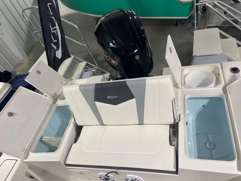 Slide: The Image of 2024 Robalo 246 Cayman boat interior with storage compartments and outboard motor. - 8