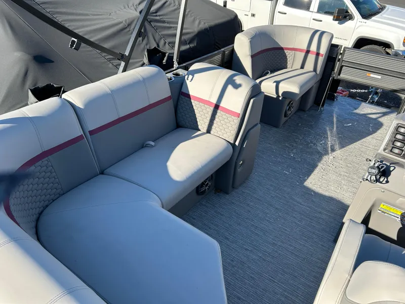 Slide: The Image of 2023 Qwest 818 XRE Cruise boat interior with gray seating and red accents. - 10