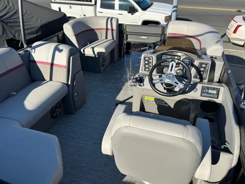 Slide: The Image of 2023 Qwest 818 XRE Cruise boat interior with plush seating and modern dashboard. - 11
