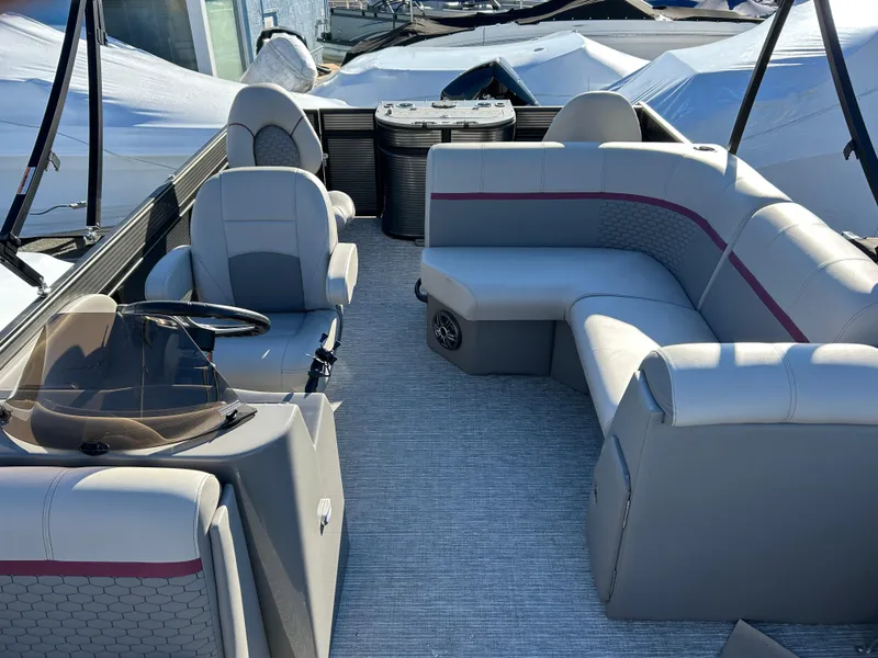 Slide: The Image of 2023 Qwest 818 XRE Cruise boat interior with gray seating and steering console. - 5