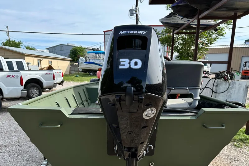 Slide: The Image of 2022 Jon Boat Aluminum Boat with Mercury 30 outboard motor in a parking lot. - 6