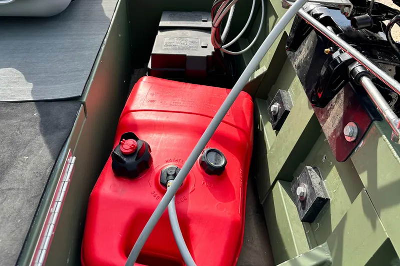 Slide: The Image of 2022 Jon Boat Aluminum Boat interior with red fuel tank and battery. - 10
