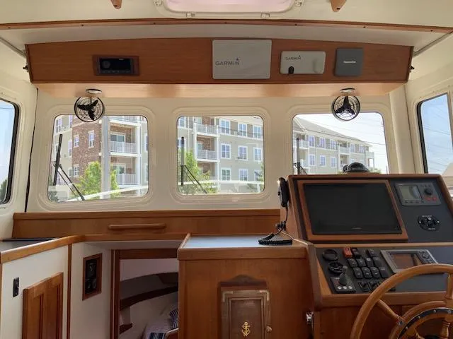 Slide: The Image of Interior view of a 2010 Nordic Tug 32 boat cockpit with navigation equipment. - 14