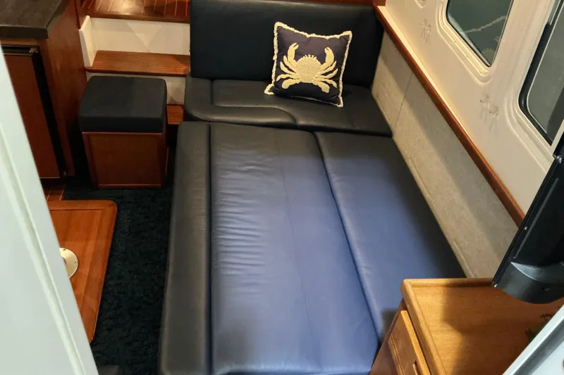 Slide: The Image of Interior of 2010 Nordic Tug 32 with blue leather seating and crab-themed pillow. - 24