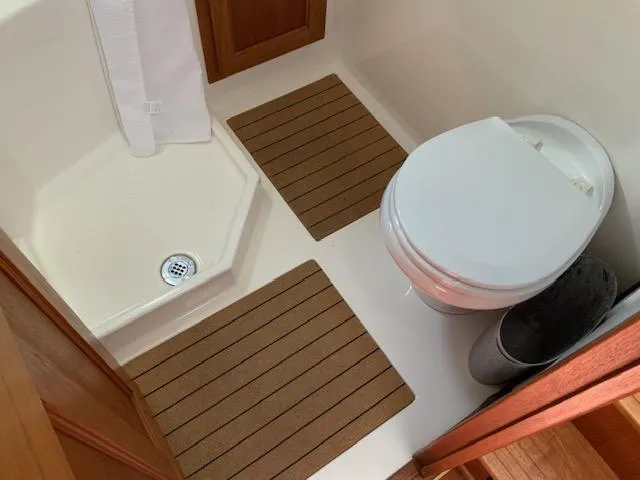 Slide: The Image of Bathroom interior of a 2010 Nordic Tug 32, featuring a shower and toilet. - 34