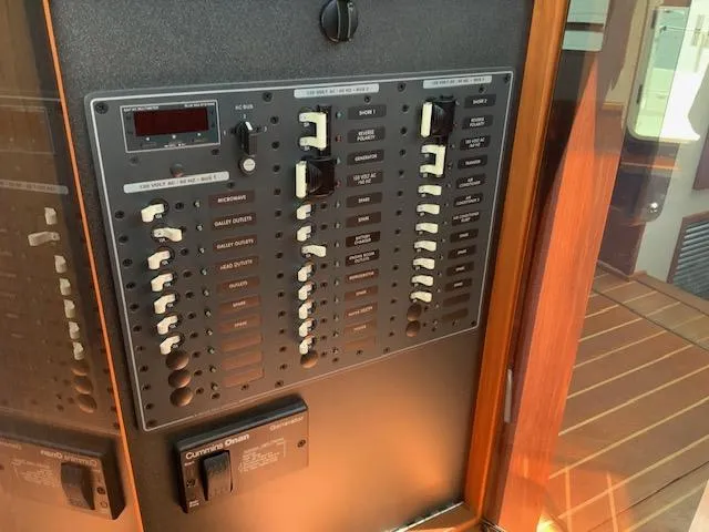Slide: The Image of Electrical panel on a 2010 Nordic Tug 32 boat, featuring multiple switches and controls. - 37