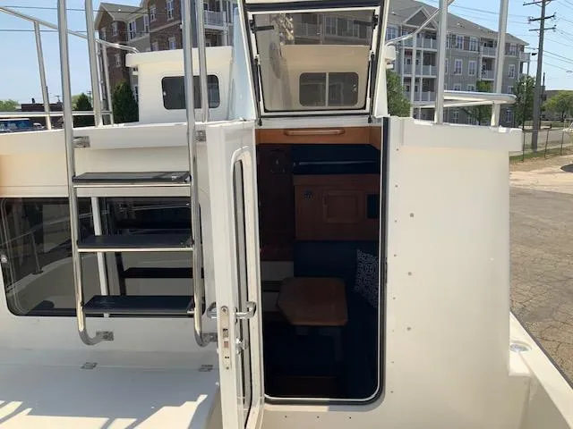 Slide: The Image of 2010 Nordic Tug 32 boat with open cabin door and exterior ladder. - 39