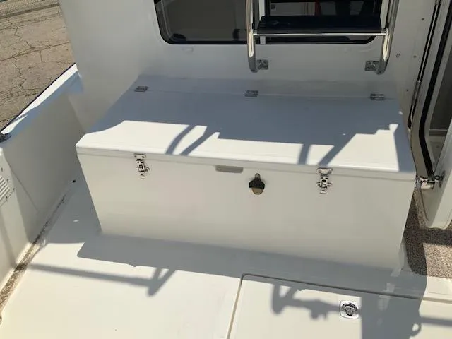 Slide: The Image of Nordic Tug 32 (2010) boat deck with storage compartment and metal railing. - 40