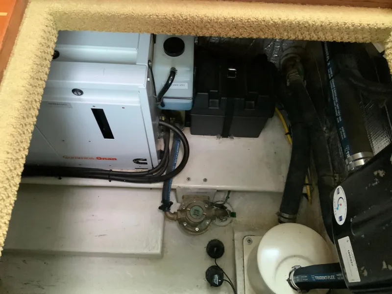 Slide: The Image of Engine compartment of a 2010 Nordic Tug 32, featuring mechanical and electrical components. - 43