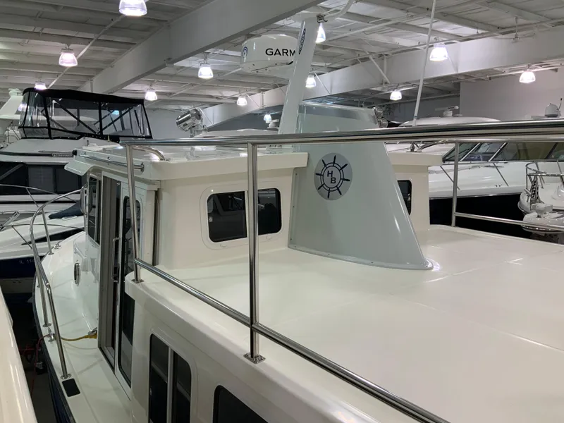 Slide: The Image of 2010 Nordic Tug 32 yacht displayed indoors with sleek design and modern features. - 9