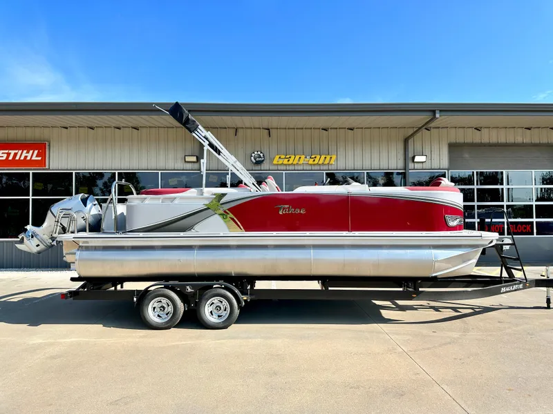 Slide: The Image of 2023 Tahoe Pontoon LTZ QUAD Lounger 23 FT Triple 25 SP in red, parked on a trailer. - 0