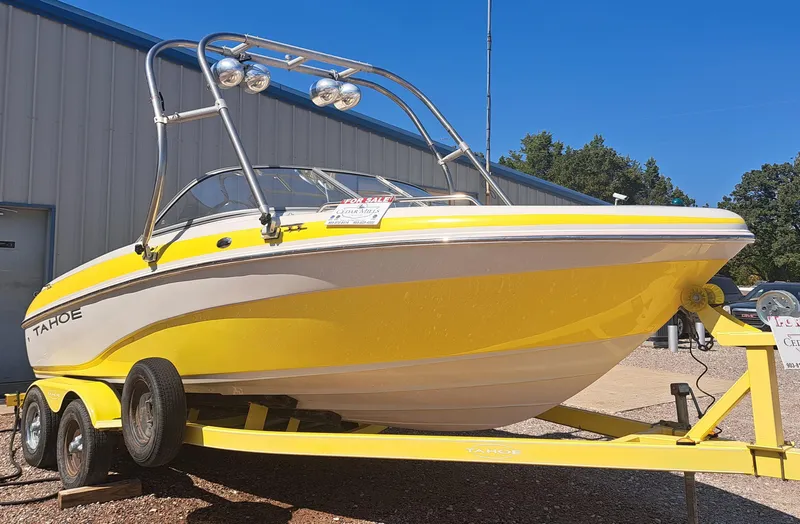Slide: The Image of Yellow 2006 Tahoe Q-6 boat on trailer, parked outdoors. - 1