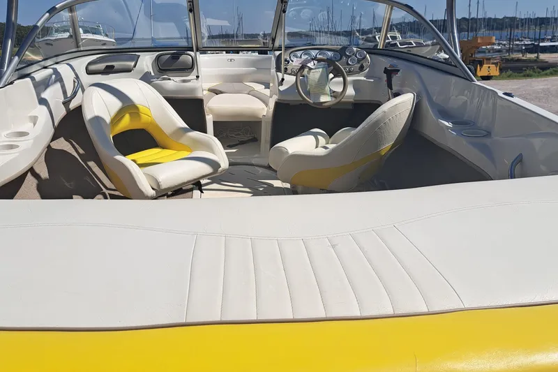 Slide: The Image of Interior of a 2006 Tahoe Q-6 boat with yellow and white seating. - 4