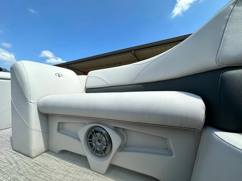 Slide: The Image of 2023 Tahoe Pontoon SLT 1980 GL boat seat with built-in speaker under blue sky. - 12