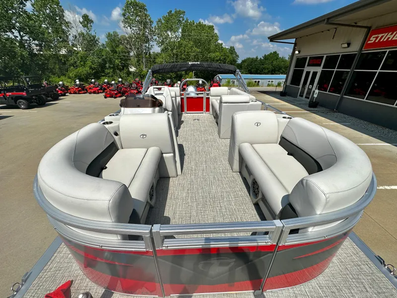 Slide: The Image of 2023 Tahoe Pontoon SLT 1980 GL boat with spacious seating, docked at a dealership. - 3