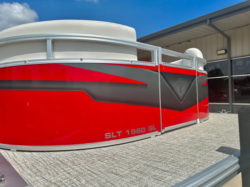 Slide: The Image of 2023 Tahoe Pontoon SLT 1980 GL in red and black, docked under a clear blue sky. - 5