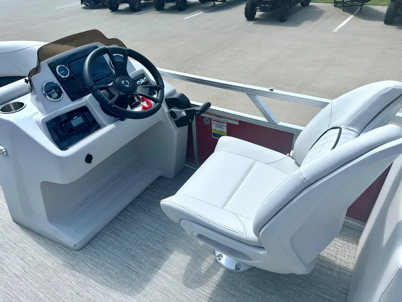 Slide: The Image of 2023 Tahoe Pontoon SLT 1980 GL boat cockpit with steering wheel and captain's chair. - 9