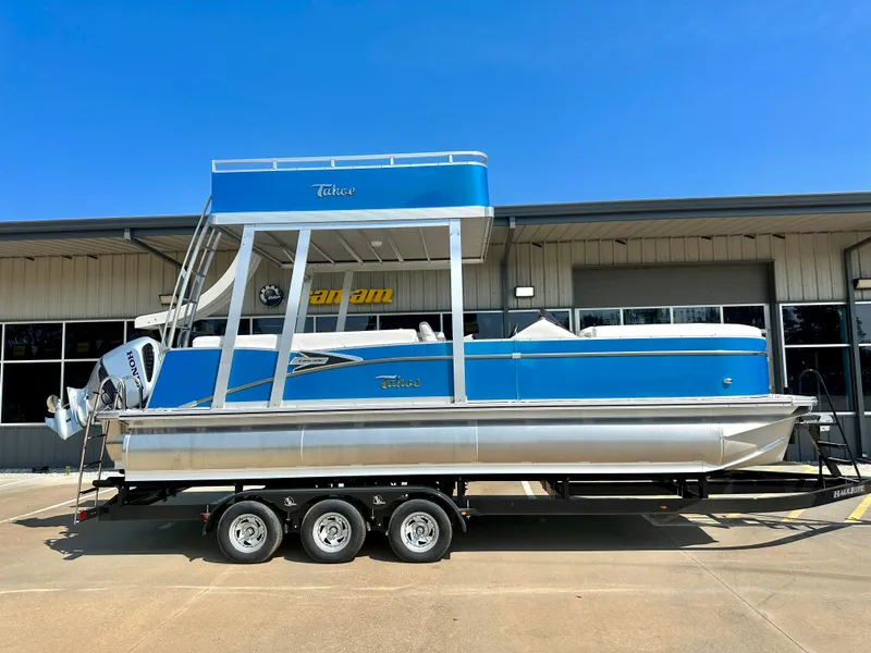 Slide: The Image of 2023 Tahoe Pontoon Cascade Cruise ENT 25 FT Triple 25 WG on trailer, blue and silver. - 4