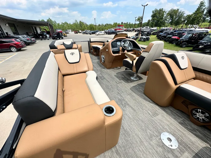 Slide: The Image of 2023 Tahoe Pontoon Cascade Elite 23 FT interior with tan and black seating, modern dashboard. - 12