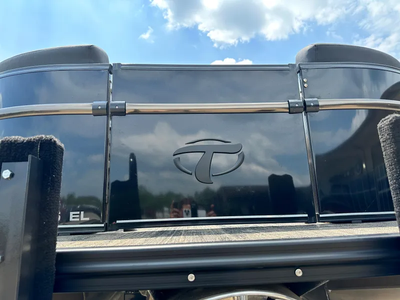 Slide: The Image of 2023 Tahoe Pontoon Cascade Elite 23 FT, black exterior, under a blue sky. - 4
