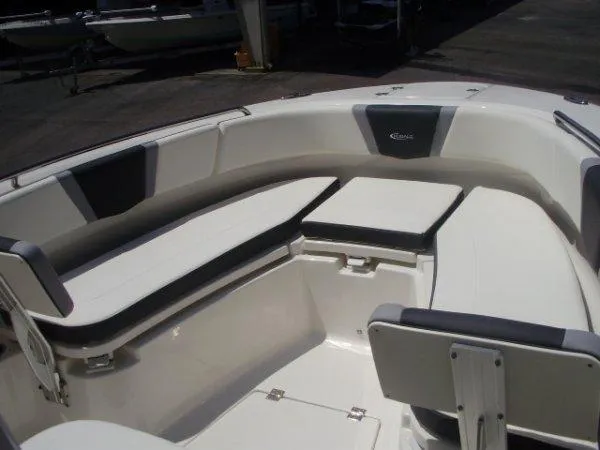 Slide: The Image of 2023 Robalo R250 boat interior with cushioned seating and storage compartments. - 10