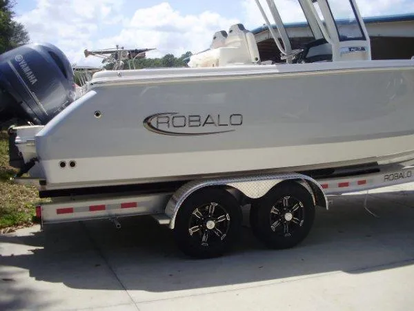 Slide: The Image of 2023 Robalo R250 boat on a trailer with Yamaha outboard motor. - 13