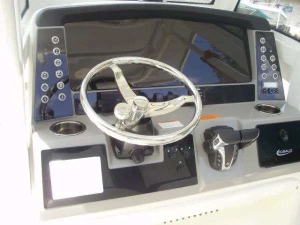 Slide: The Image of 2023 Robalo R250 boat dashboard with steering wheel and control panel. - 3