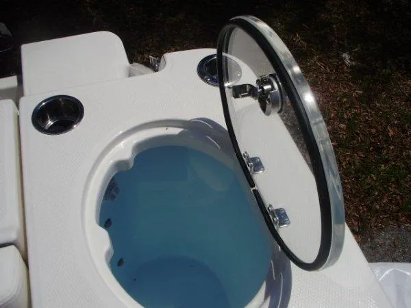 Slide: The Image of 2023 Robalo R250 livewell with open lid and cup holders. - 4