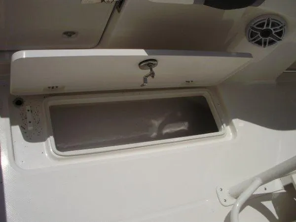 Slide: The Image of 2023 Robalo R250 boat storage compartment with open hatch. - 5