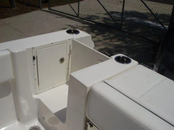Slide: The Image of 2023 Robalo R250 boat interior with storage compartment and cup holders. - 7