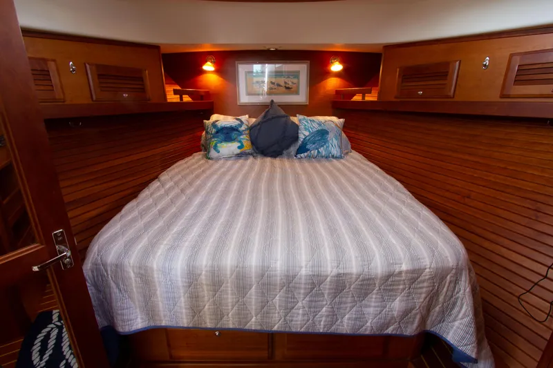 Slide: The Image of 2010 Sabre 40 Hardback Express cabin with cozy bed and wooden interior. - 24