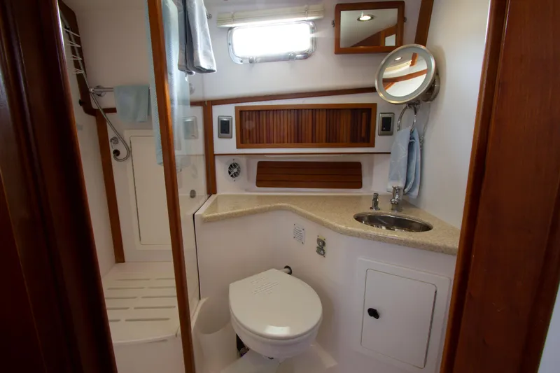 Slide: The Image of 2010 Sabre 40 Hardback Express yacht bathroom with sink, toilet, and shower. - 25