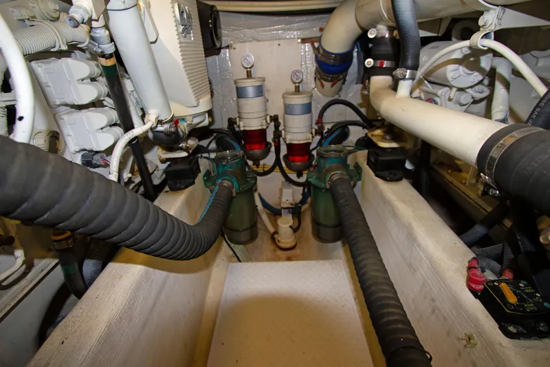 Slide: The Image of Engine room of a 2010 Sabre 40 Hardback Express boat showing hoses and filters. - 27