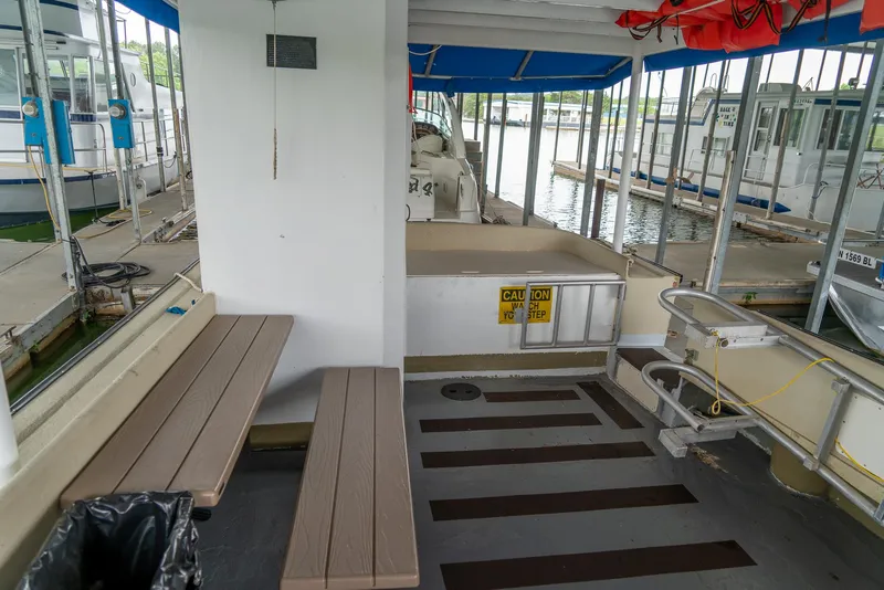 Slide: The Image of Interior of a 2004 Custom 40' Navy Boat docked at a marina. - 10