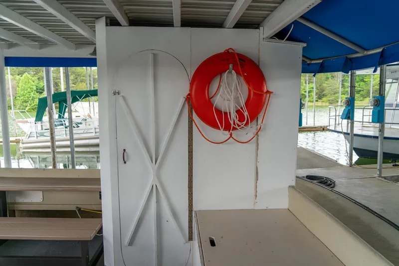 Slide: The Image of 40' Navy Boat (2004) with life preserver and docked at marina. - 11